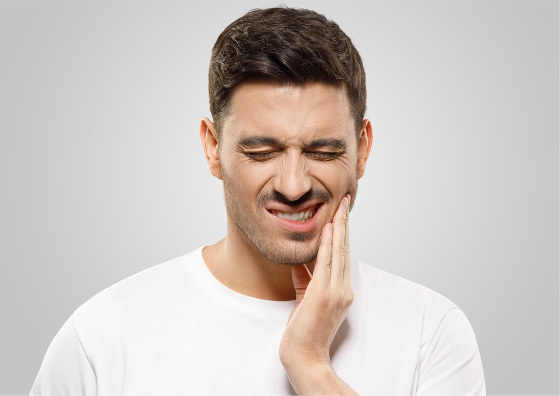 Man with Jav pain Holding Face